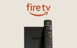 Fire TV Stick lying next to its remote